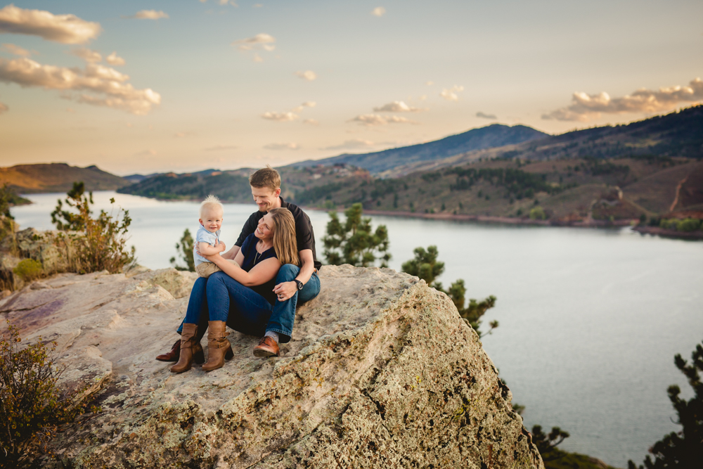 Photo of a family of three on a beautiful cliff overlooking Horsetooth Reservoir