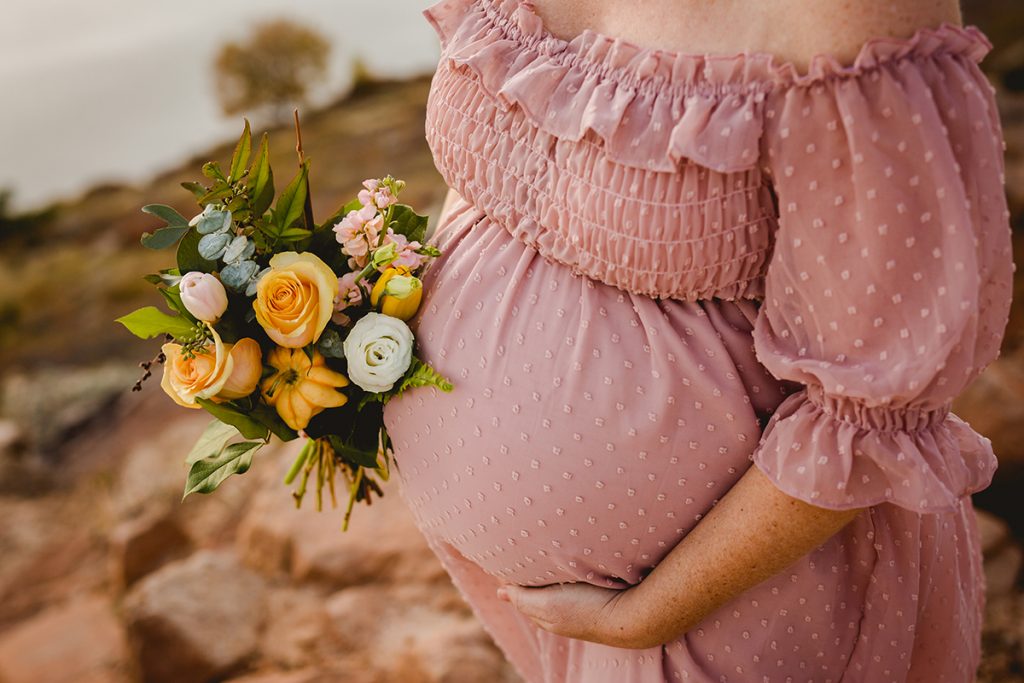 Maternity photo including a fall bouquet of flowers