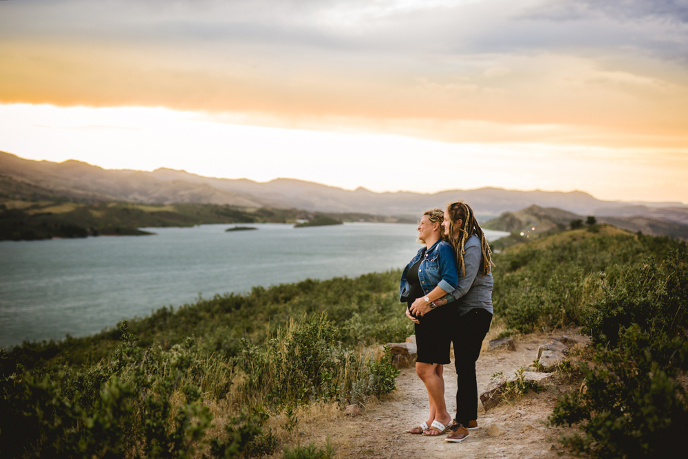 Maternity photo of a couple at Horsetooth Reservoir at sunset
