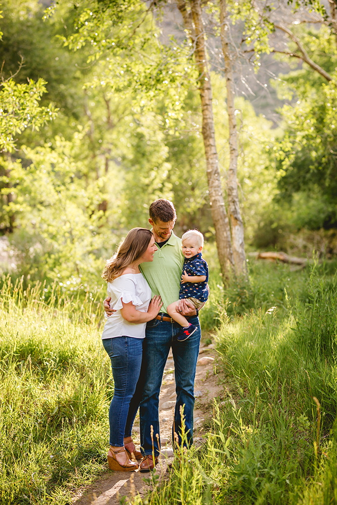 Portrait of a family of three in the woods in Northern Colorado