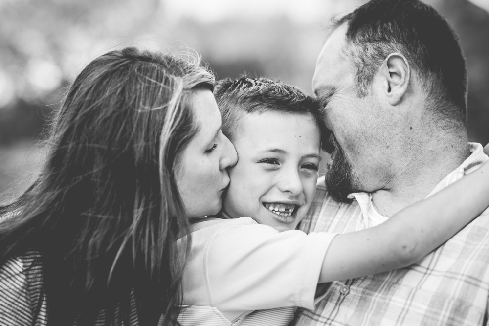 Mom and dad kiss their boy on the cheeks in a photo taken by Becky Michaud, Fort Collins photographer