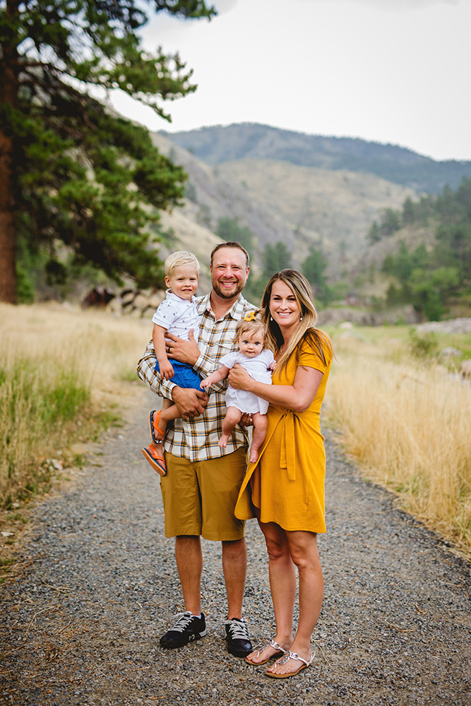 family of four in the mountains near Loveland Colorado poses for their photographer