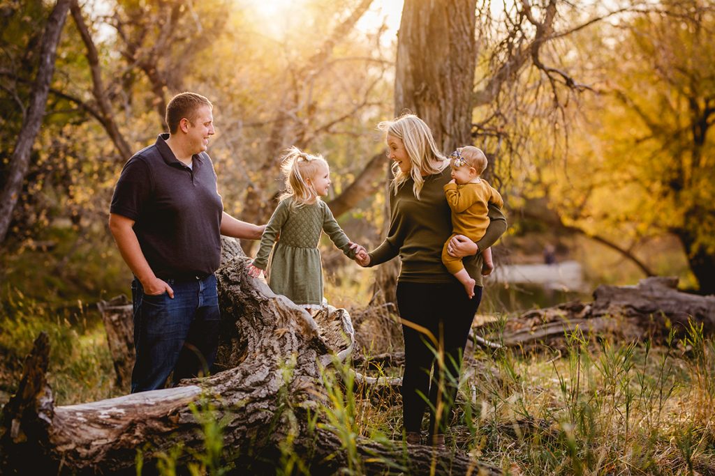 A family plays together in the forest for their family photography session Fort Collins, Colorado