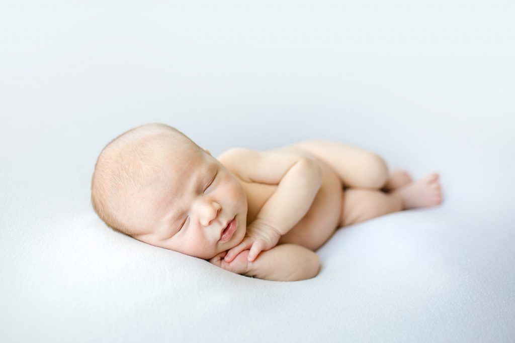 Simple, timeless photo of a newborn baby on white taken by Becky Michaud, Fort Collins photographer