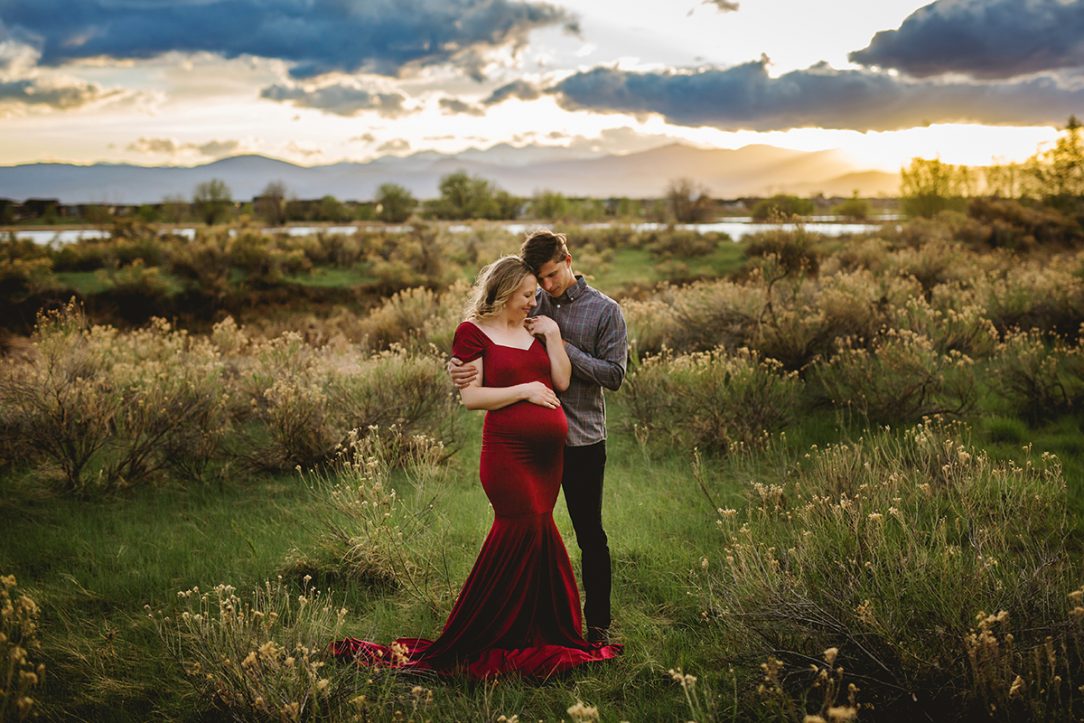 Maternity photography featuring a couple at sunset with mom wearing the Chicaboo Athena gown in Northern Colorado