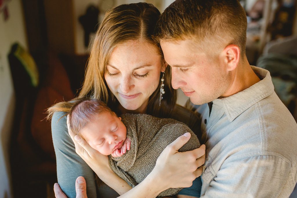 family photo from an in home newborn session of mom and dad with their baby boy in Fort Collins, Colorado