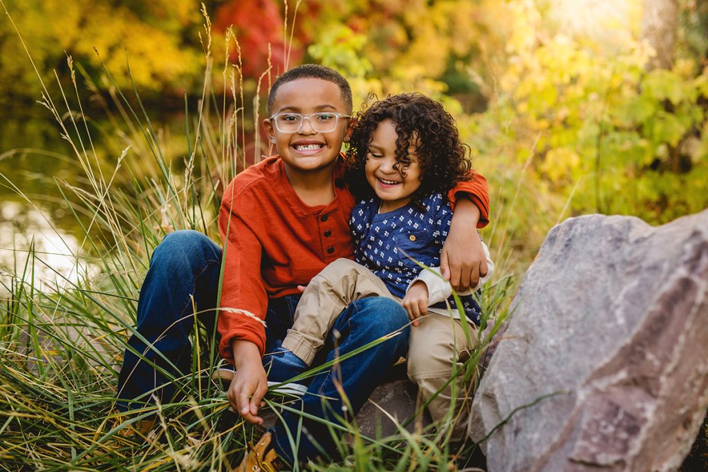 two brothers play together during their fall family photo session at a Fort Collins natural area