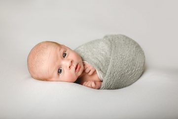 Newborn baby wide awake for his newborn photography shoot in his Northern Colorado home
