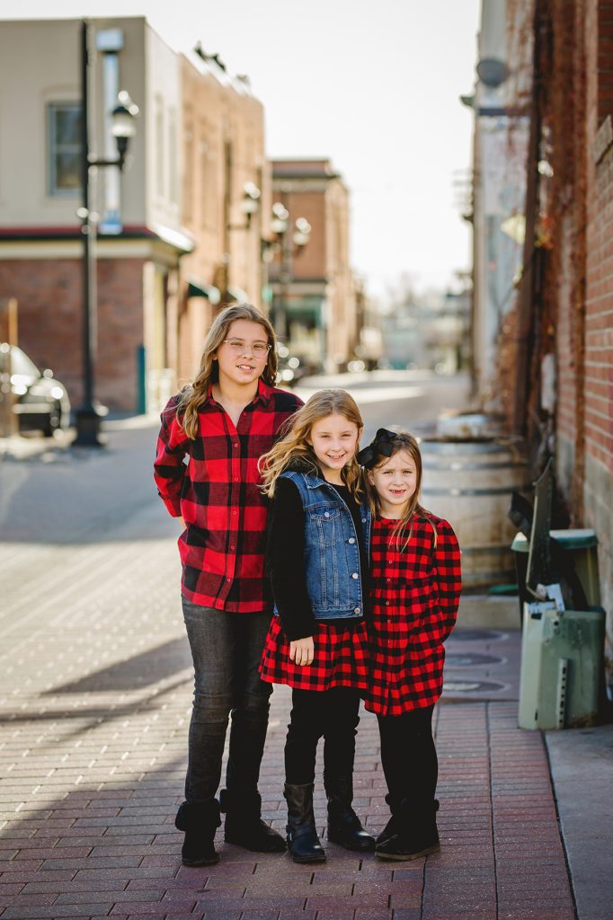3 girls pose for their portraits in Old Town Fort Collins