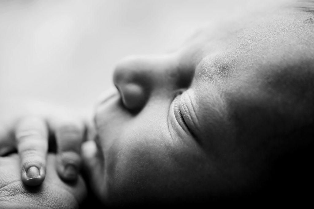 black and white macro photo of a newborn baby's profile
