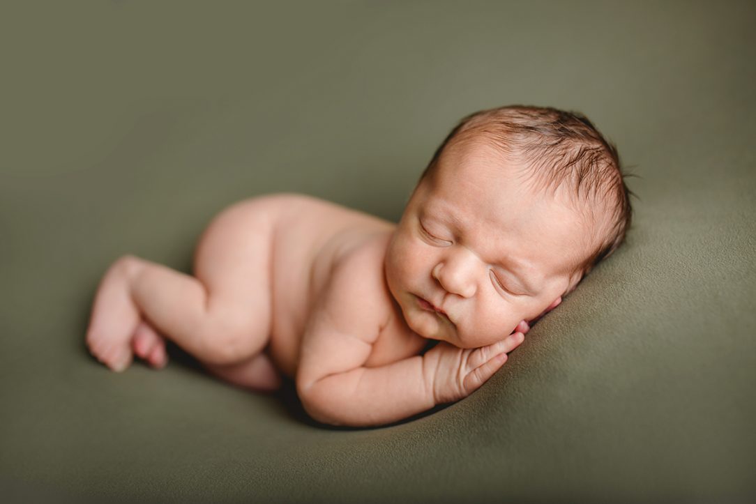 Simple timeless newborn photo of a baby on a green blanket, taken by Becky Michaud, Fort Collins photographer