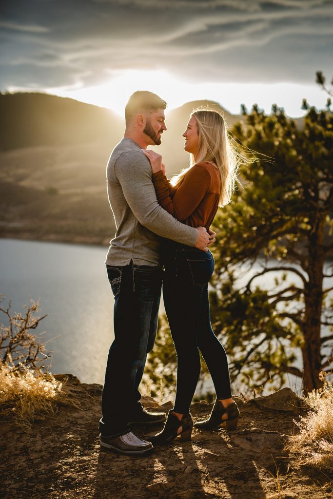 Photo taken by Becky Michaud, Fort Collins photographer, of a couple standing together on the rocks overlooking Horsetooth Reservoir